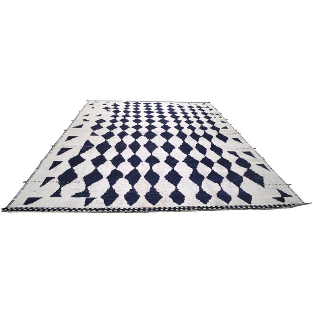 Hand-knotted with care using traditional rug making techniques, this wool rug blends timeless craftsmanship with a modern...