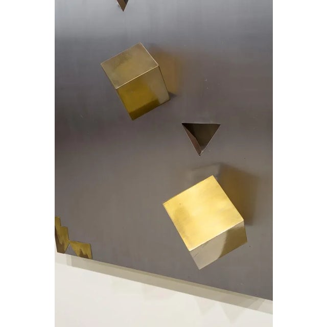 Rectangular panel in soul of solid wood chape in gold steel and golden metal in relief. On a silver steel surface three...