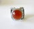 Handmade sterling silver modernist ring with carnelian cabochon created by James Parker of San Diego, California. Ring is...