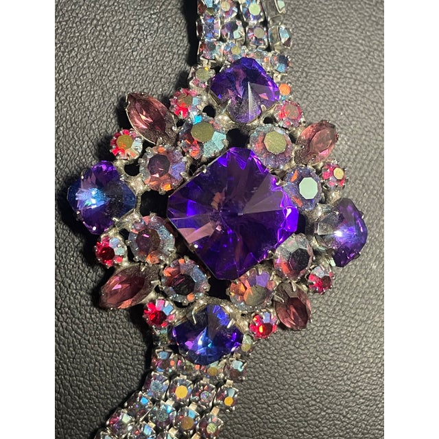 This vintage DeLizza & Elster (Juliana) bracelet features a multi-strand band with a dramatic, cluster-style central...