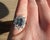 Vintage Daisy Ring from the 1990s, made in 18 Carat White Gold (750 thousandths). The ring is set with a natural oval-...