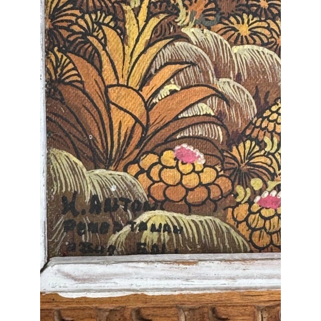 This evocative mid-century Balinese village scene oil painting captures daily life within a lush, communal landscape,...