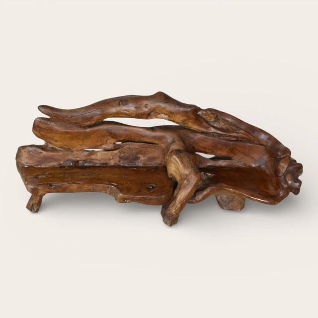A striking fusion of nature and design, this sculptural sofa is crafted from solid, organically shaped wood, preserving...