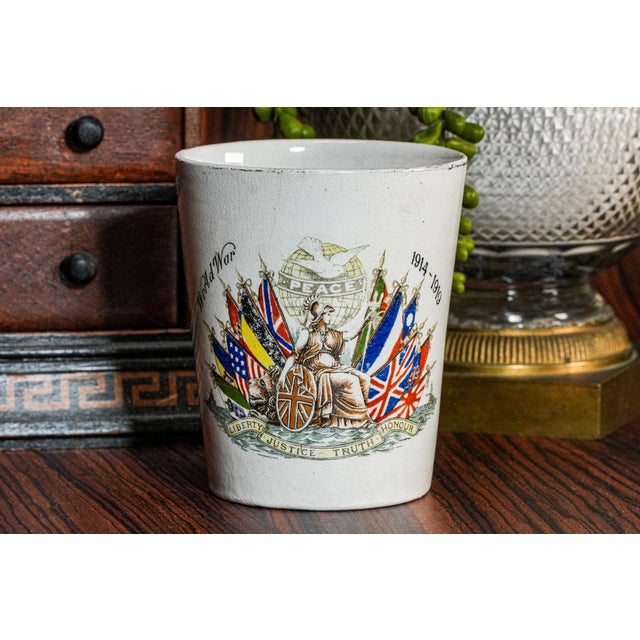 This English-made World War I porcelain beaker is a poignant and well-preserved piece of early 20th-century commemorative...