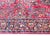A traditional early 20th century Persian Sarouk rug with a mirrored floral pattern with myriad floral clusters, surrounded...