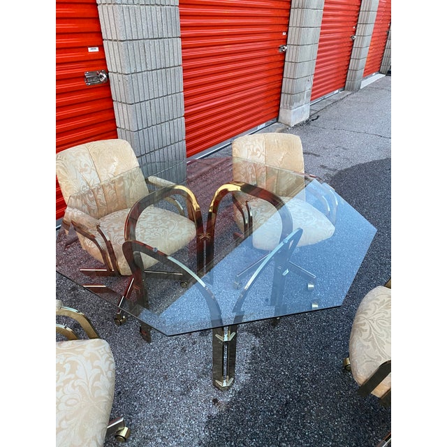 Vintage Chromcraft brass and glass dining set. Dining table with octagonal beveled glass top and brass-tone base, and four...
