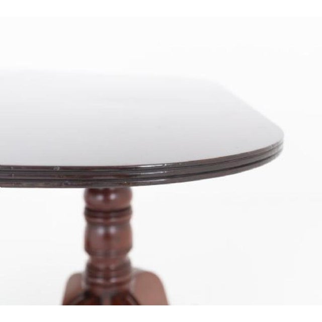 A fine Regency-period mahogany twin pedestal dining table raised upon two elegant pedestals. Each pedestal stands on four...