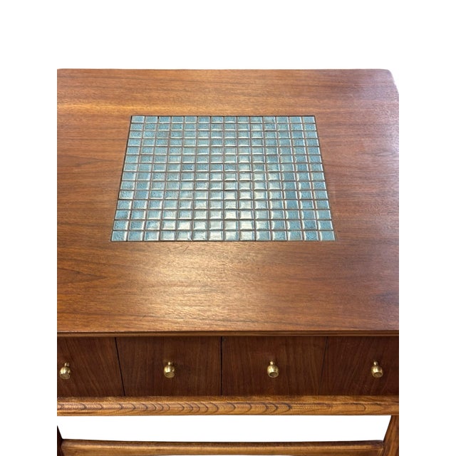 Beautiful mid-century coffee table by Lane Furniture, featuring a center drawer with brass drawer pulls, tapered legs with...