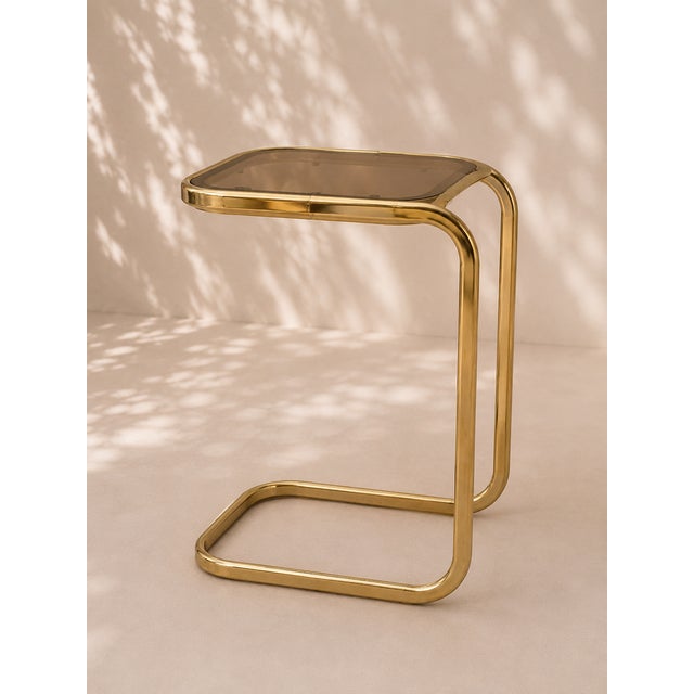 Rare set of 14 small side tables or coffee tables from the 1970s, crafted from gilded metal (brass) and topped with...