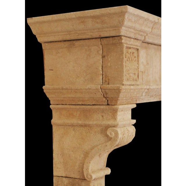 Crafted in the 20th century with reverence for Old World design, this hand-carved limestone fireplace mantle evokes the...