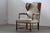 This exceptional vintage wingback armchair, requiring new upholstery, presents a compelling opportunity to restore a...