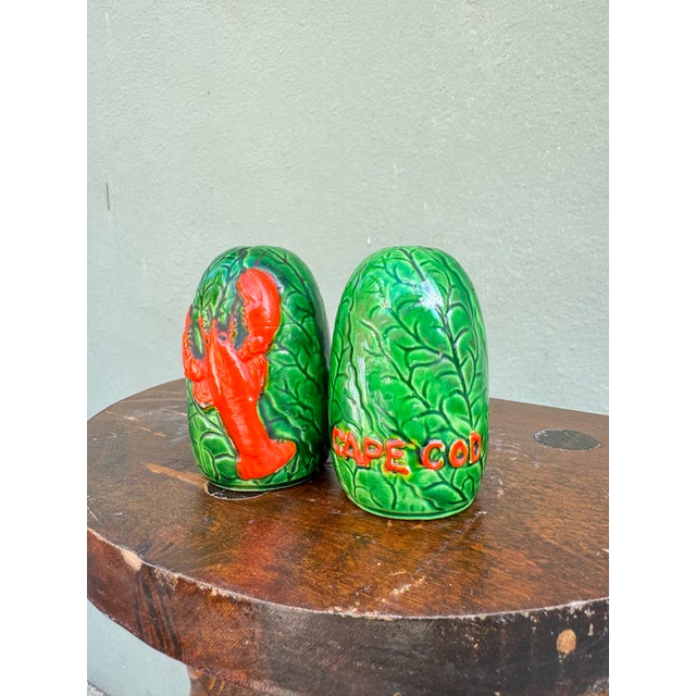 Bright red boiled lobster novelty ceramic salt and pepper shakers, marked 'Cape Cod' on the underside. An authentic...