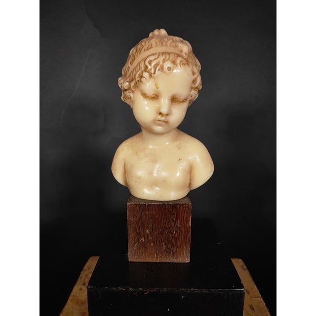 XIX Century child wax bust. Curious bust in wax representing a child of the xix century on wooden base total measurements:...