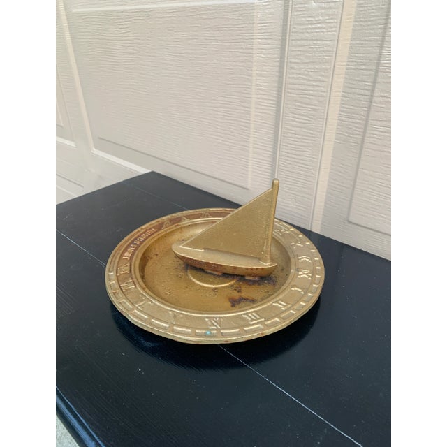 A beautiful vintage cast iron nautical garden sundial with a boat, reading "Tempus Fugit," which translated from Latin...