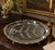 An elegant vintage silverplate carving platter featuring a traditional raised tree-and-well design, an ornate floral and...