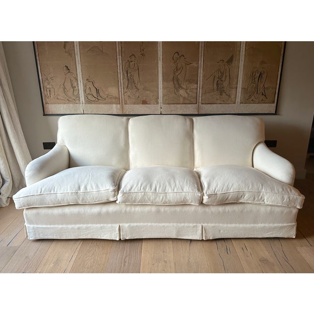 A large 3-seater Howard style sofa, made by Peter Dudgeon. Recently reupholstered in cream/white linen. The Peter Dudgeon...