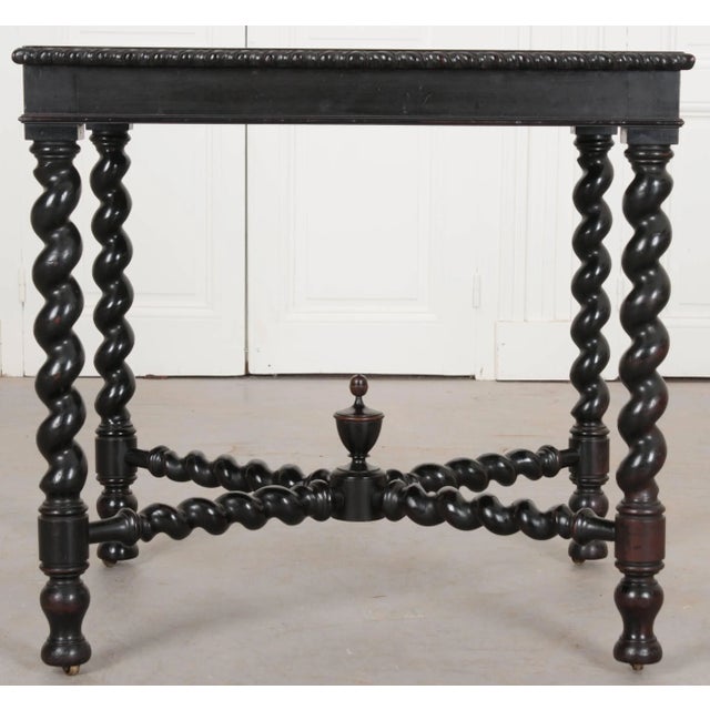 A striking Italian ebonized table from the 19th century with an inset top of rust-colored "Scagliola", a kind of faux-...