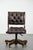 Luxurious and elegant English-style Chesterfield office chair made of cowhide and wood, on casters. : This luxurious brown...