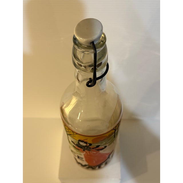 Burnt Orange Vintage Art Nouveau “Ice Water” Swing Top Glass Bottle Featuring Victorian Lady Skating For Sale - Image 8 of 12