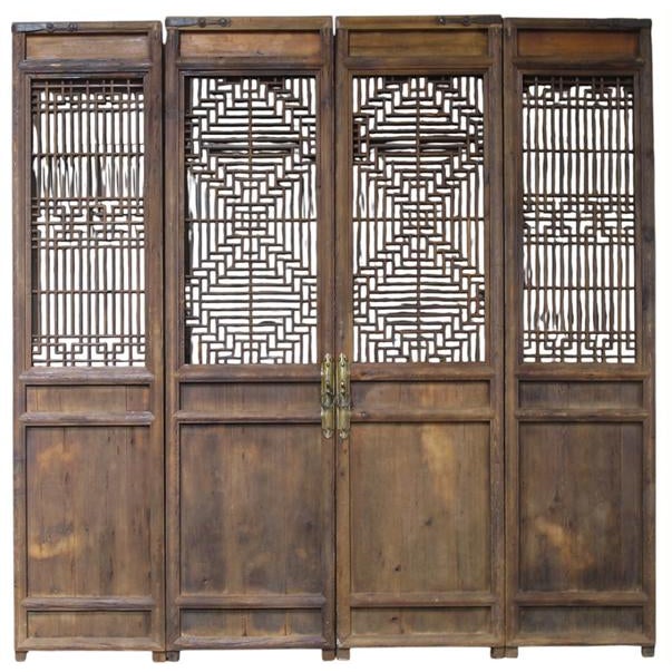 This 4 panel set of antique Chinese screen doors showcase a blend of traditional craftsmanship through its intricately...