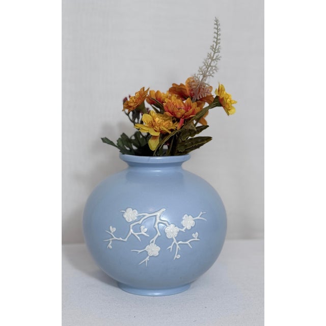 A refined vintage Copeland Spode England ceramic vase featuring a soft powder-blue glaze accented with applied white...