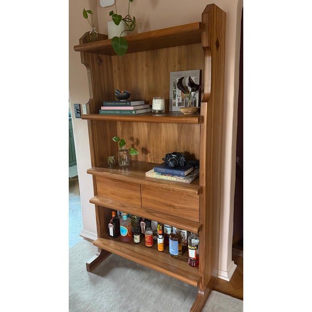 This bookshelf is robust in construction with graceful contours. With the added drawers, it has a high level of...
