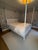 Queen size canopy bed attributed to OLY Studio featuring refined bamboo-style turnings, crisp white lacquer finish, and...