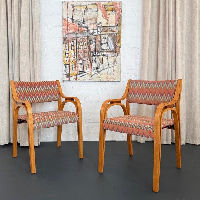 This is a highly unique pair of Mid-Century Modern bentwood armchairs is in the style of Don Petit for Knoll or Thonet....