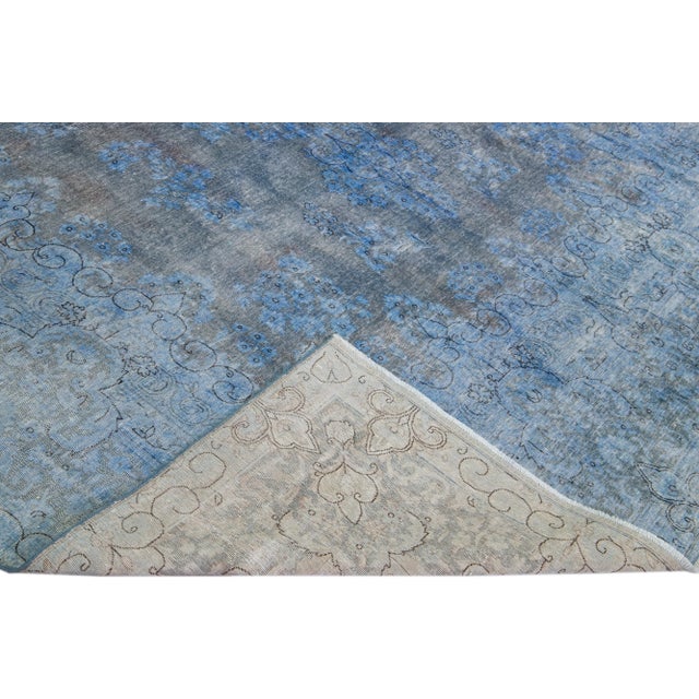 Beautiful Vintage overdyed hand-knotted wool rug with a blue field. This persian rug has gray accents in an all-over...