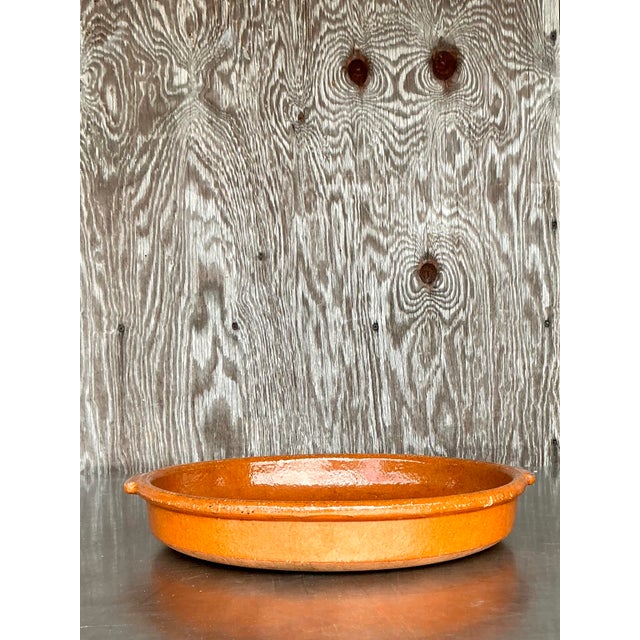 This stunning vintage boho ceramic tray showcases a beautifully rich, hand-glazed finish in a warm terracotta hue. Its...