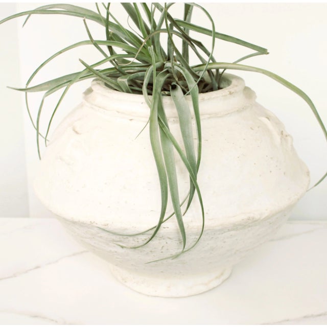A charming white paper mache vase handcrafted in India, Made from recycled paper, this vase showcases the artistry of...