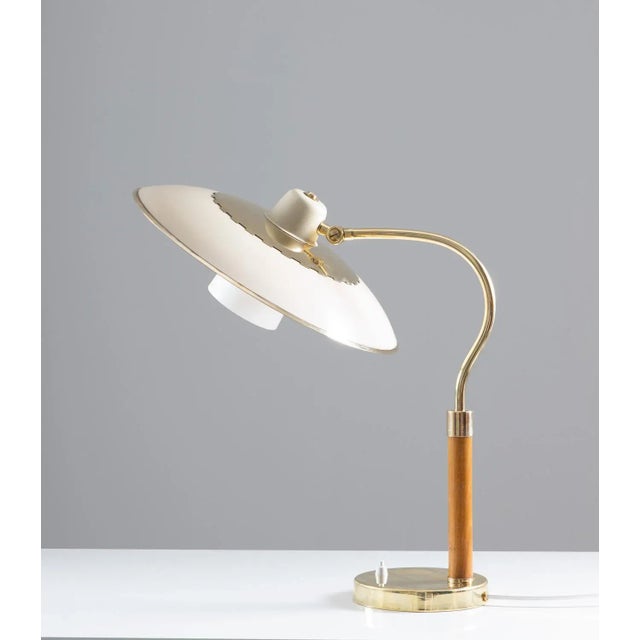 Swedish Mid-Century Modern table lamp in brass, glass and wood, produced by Boréns, 1940´s. The lamp consists of a large...