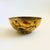 A vintage brass bowl with a lovely vine design applied to the exterior. Colorful beads have been embedded on the surface....