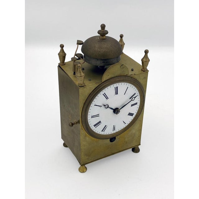 Rare Swiss Capuchin clock from the first half of the 19th century, with a brass case and four turned feet and pinnacles....