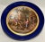 This large French porcelain charger, in the Sèvres style, is intricately painted with a period courtyard scene, set in the...