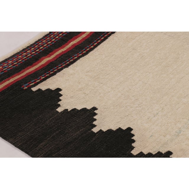 Handwoven in wool, this contemporary 5x6 Rez Kilim enjoys a minimalist geometric design with an open ivory field framed by...