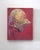 This oil on panel piece presents a striking portrayal of a helmet, intricately adorned with mythological scenes of the...