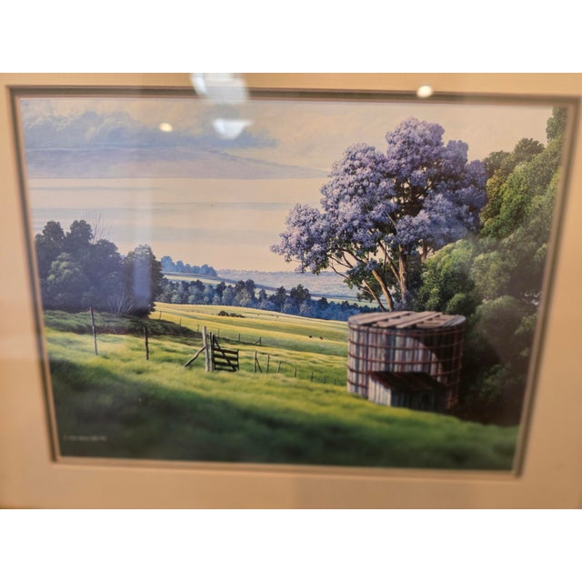 A finely detailed pastoral landscape print signed "Curtis Wilson Cost," dated 1985. The scene depicts a sunlit rural field...