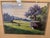 A finely detailed pastoral landscape print signed "Curtis Wilson Cost," dated 1985. The scene depicts a sunlit rural field...