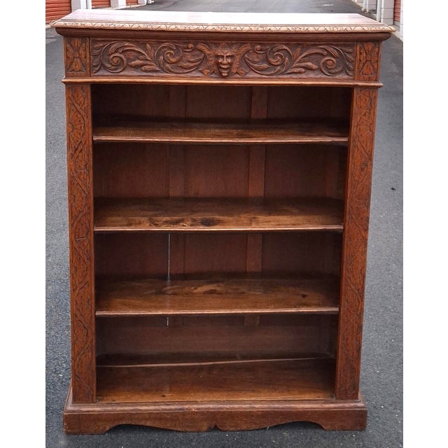 A late victorian Arts and crafts style Carved Oak Bookcase. Adjustable Height shelves. Measuring 36" in width, 13.5" in...