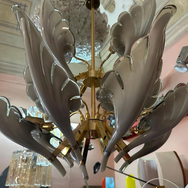 This chandelier is a striking example of Mid-Century Modern design with a touch of Hollywood Regency flair. It's glamorous...