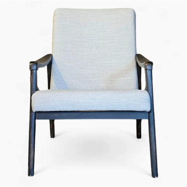 Low slung and sleek, this 1960s Czech modernist arm chair, reupholstered in gray flannel, lends a sophisticated touch to...