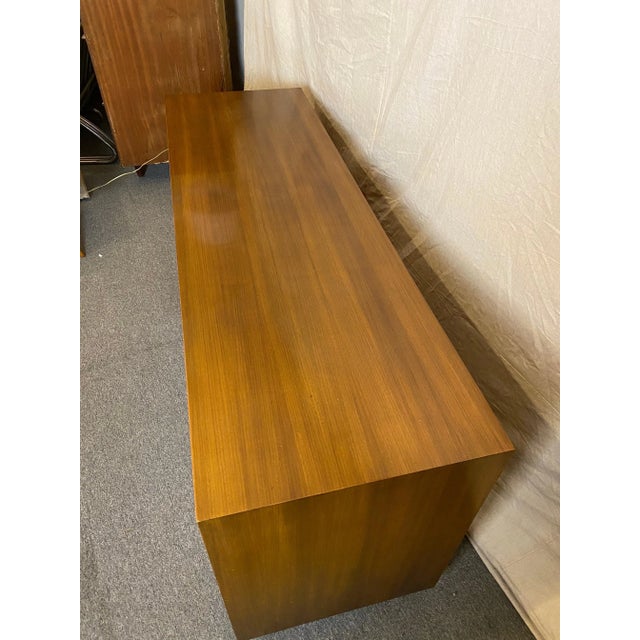 Vladimir Kagan for Kagan/ Dreyfuss walnut credenza or bedroom cabinet. Tambour doors with brass handles at each end slide...