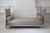 An elegant Louis XVI style daybed, dating from the early 19th century. Made of molded wood and richly carved with acanthus...