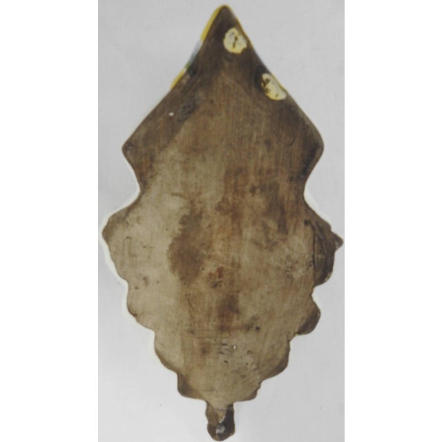 A cherubic angel graces the center of this ceramic Holy Water Font. Swirls of blue surround the perimeter as well as on...