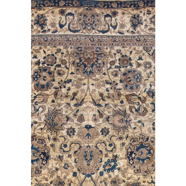 A palace size formal Indian rug containing an ivory field with accents of denim blue. Finely woven in a large Indian...