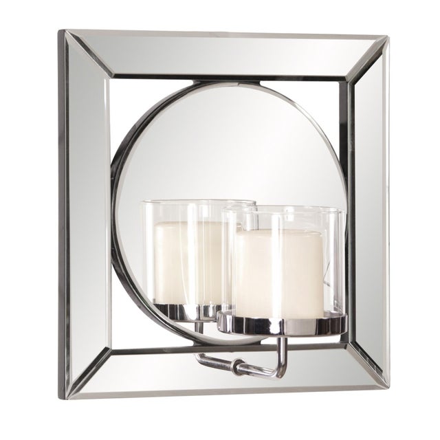 The Lula Mirror features a square mirrored frame set around a round mirror. The mirrored frame on this piece has a small...
