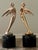 Vintage Hollywood Regency style winged abstract figural Telly award statues, gold tone plated metal with round black...