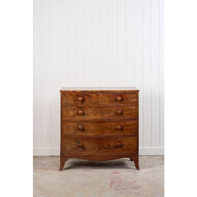 This early 19th-century flame mahogany chest showcases a rich woodgrain with swirling, bookmatched patterns. Its...
