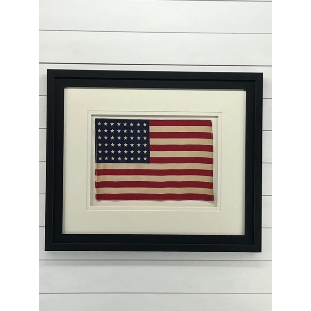 Vintage 48 star American Flag. Printed parade flag made of cotton with sewn edges. Stars are in typical straight even...